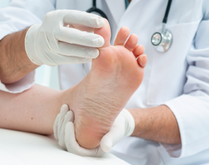 A podiatrist assisting a client with wound care services.
